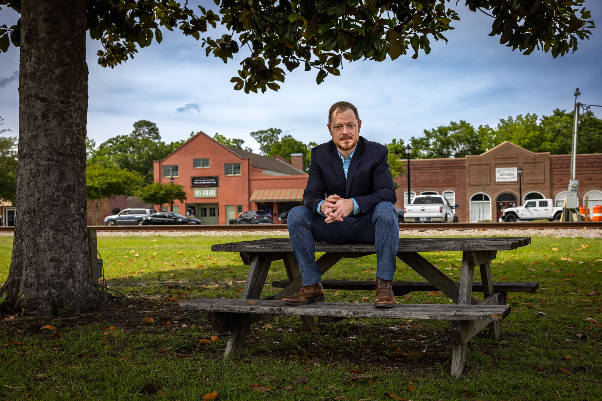Chris Benson is pictured sitting on top of a picnic table. Chris Benson is pictured sitting on top of a picnic table.