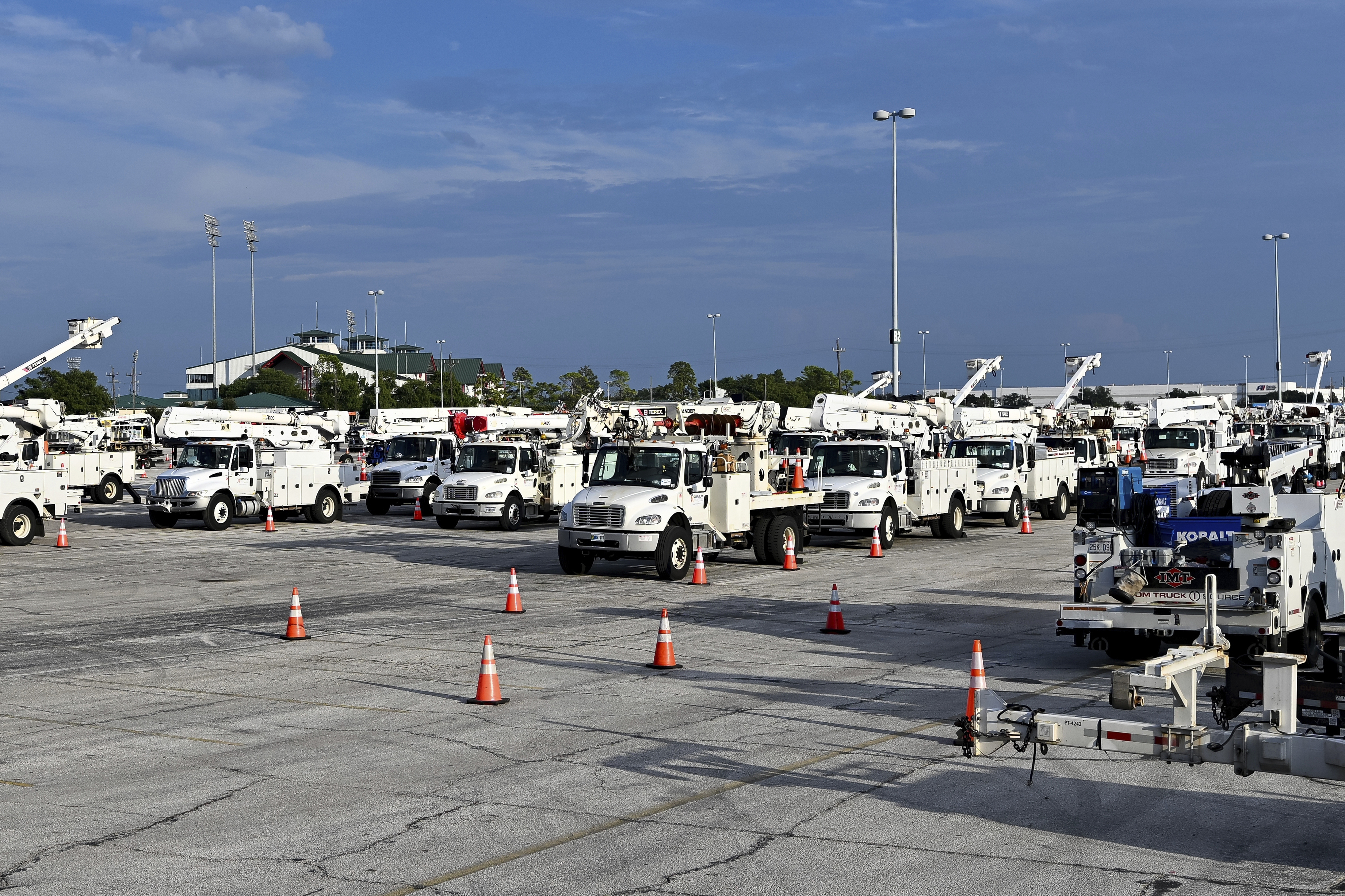 Utility trucks sit parked.