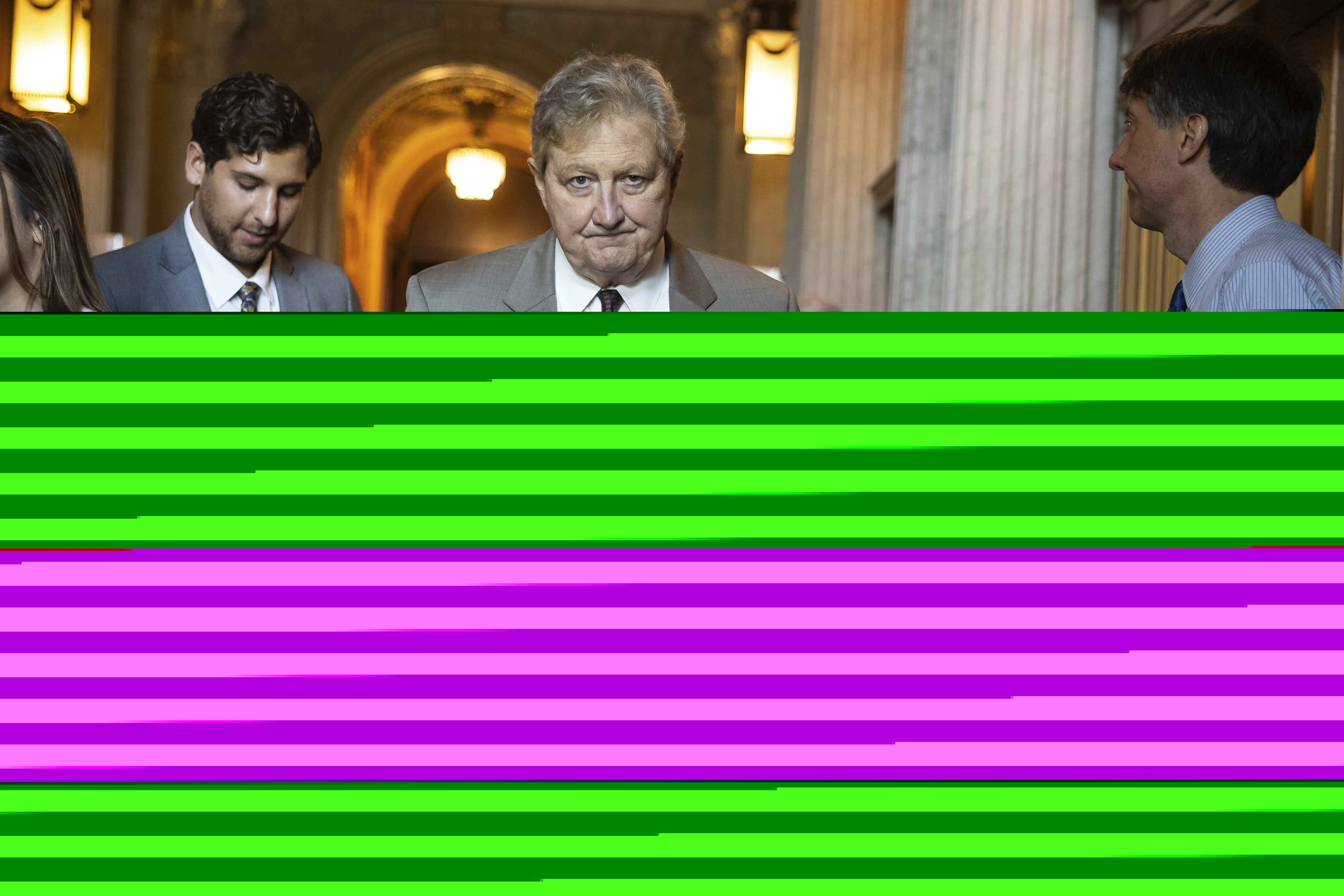 Sen. John Kennedy is seen walking and holding a folder. Sen. John Kennedy is seen walking and holding a folder.
